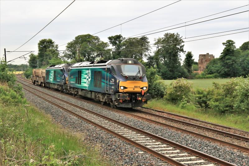 Class 68 on 6S43: 68016 + 68018 on 6S43 06.23 Carlisle to Torness passing Redcastle on 22/06/2017. Trees are starting to spoil the view all trees are on Railway land. 12 class 68 have been on this train. Photo of Class 68 on 6S43