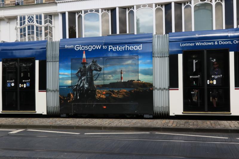 Tram Vinyl Glasgow to Peterhead: Each tram has one unique vinyl.
matching colours on the traffic cone & Lighthouse Photo of Tram Vinyl Glasgow to Peterhead