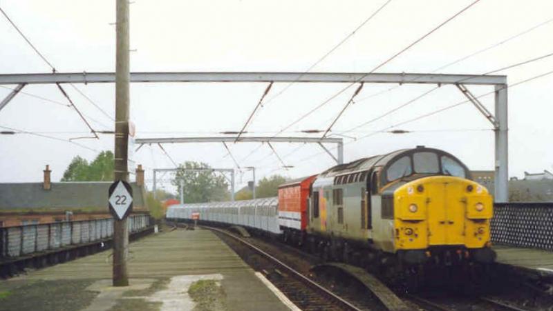 37063: Taken at Coatbridge Central in 1991 heading a train of London Tube stock to Rosyth for refurbishment. Photo of 37063
