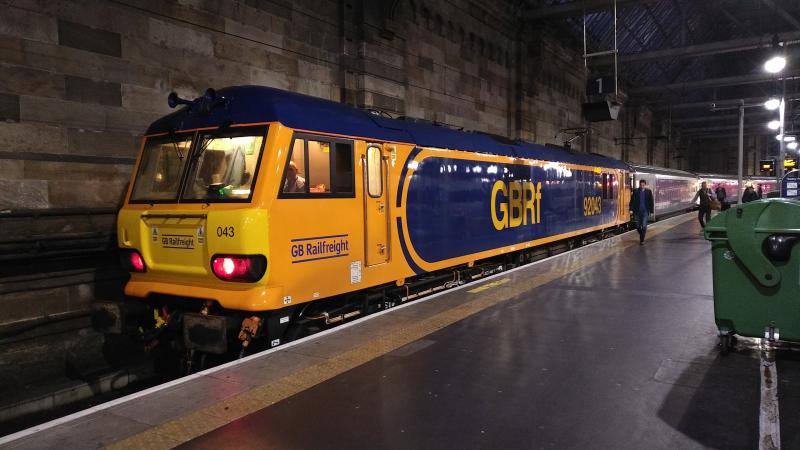 92043 on 1S26: 92043 arrives at Glasgow Central on its maiden voyage to Scotland after refurb and repaint and duly arrives on time with 1S26 sleeper service from London Euston Photo of 92043 on 1S26