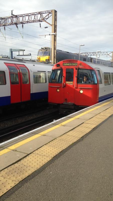 92018/1972 stock: 92018 seen stabled overlooking Stonebridge Park with a 1972 stock train arriving bound for Elephant & Castle and a terminating train in Platform 1 Photo of 92018/1972 stock