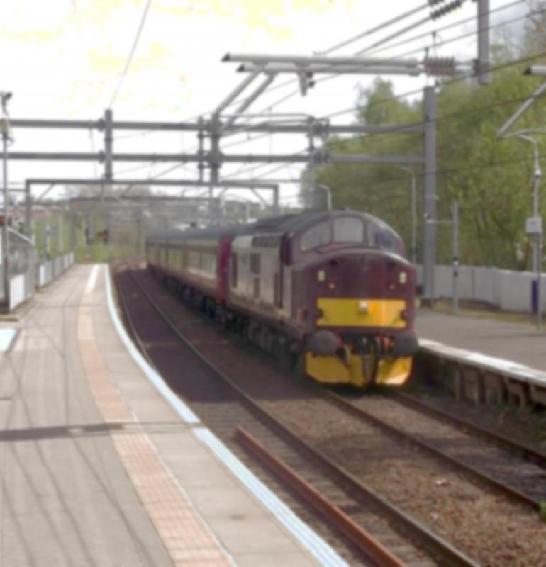 37516 at Springburn: West Coast Railways 37516 passes Glasgow Springburn, wit 5Z40, an ECS from Carnforth to Fort William on Thursday 10th May 2018. This is the stock for the Summer Jacobite Steam train, from Fort William to Mallaig. Photo of 37516 at Springburn