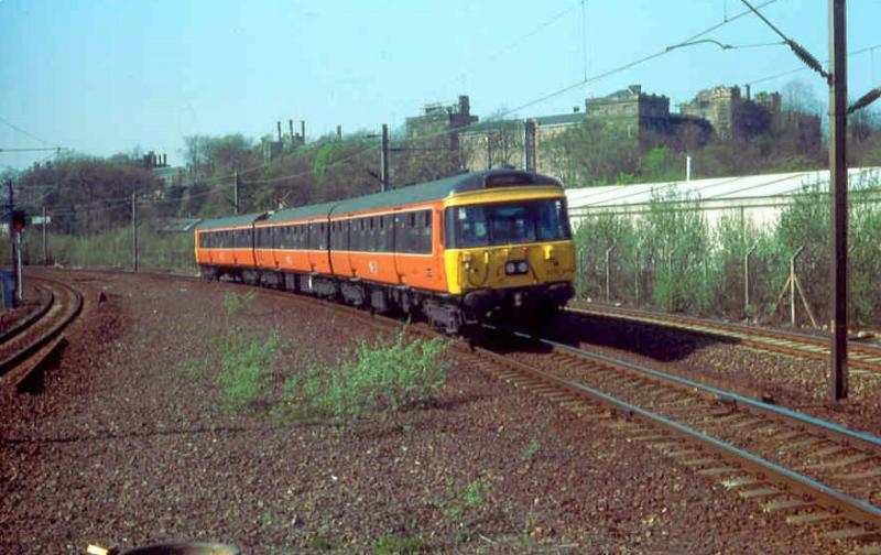 New colours: Resplendent in its newly applied Strathclyde Red, 303045 at Hyndland in April 1984. Photo of New colours