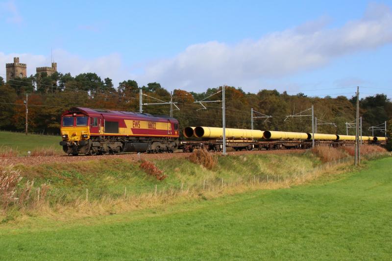 Large Yellow Pipes for Georgemas: DB's 66122 (in EWS livery) heads the 6S88 Hartlepool-Mossend near Hartwood with a load of large diameter pipes, ultimately for Georgemas. 02-Oct-18. Photo of Large Yellow Pipes for Georgemas