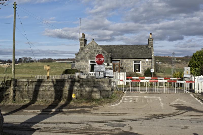 PITMEDDEN LC 19.2.19.jpg: THE LEVEL CROSSING AT PITMEDDEN ON THE ABERDEEN INVERNESS LINE ---?UNUSUAL IN THAT IS WORKED MANUALLY?
THE GRANITE BASE OF THE OLD GNSR SIGNAL BOX REMAINS INTACT---FOR NOW. Photo of PITMEDDEN LC 19.2.19.jpg