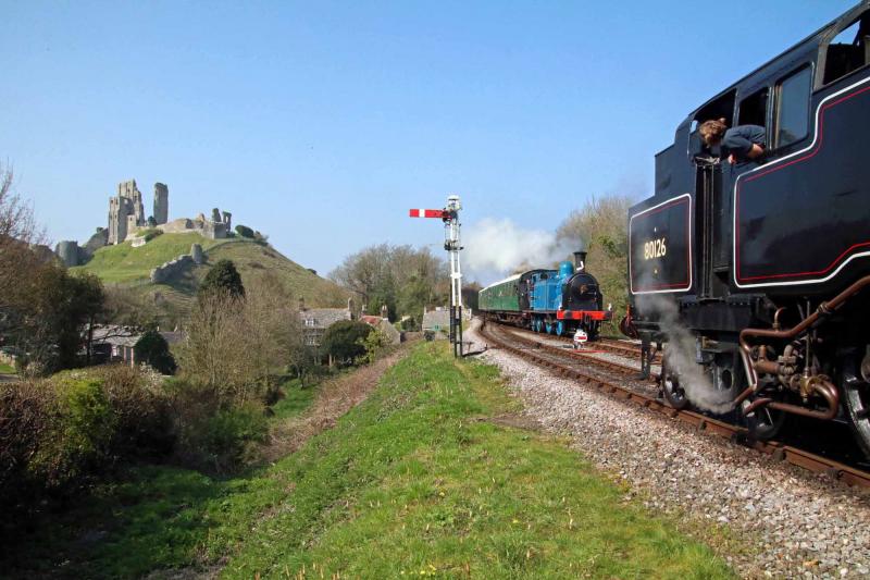 Scottish loco reunion.....sort of: Former Perth shed BR Standard 4MT 80126 waits for 419 to enter the station at Corfe Castle. The ruins of Corfe Castle dominate the scene. Photo by Andrew P.M. Wright Photo of Scottish loco reunion.....sort of