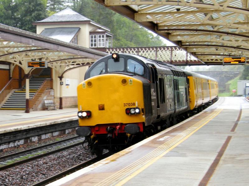 37038 @ Gleneagles - 18 May 2019: Network Rail test tain '1Q77' thunders north, from Mossend to Inverness, in heavy rain.
The only place to photograph from, out of the driving rain, was under the station's glass canopy ! Photo of 37038 @ Gleneagles - 18 May 2019