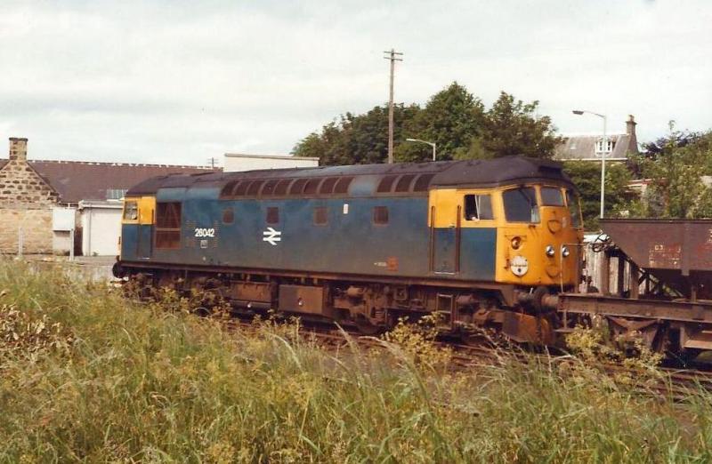 26 on ballast: Class 26 loco 26042 in Elgin yard with a ballast train for Inverness. 5/7/83 Photo Danny Hathaway Photo of 26 on ballast