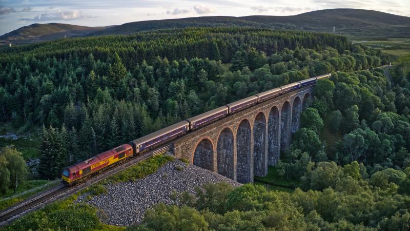 Caledonian Sleeper: 67020, still in EWS livery, hauls the Caledonian Sleeper southwards over Slochd Viaduct in the late evening sun. Photo of Caledonian Sleeper