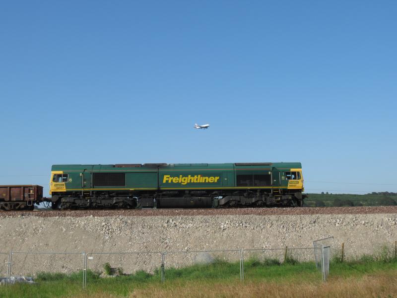 Photo of Class 66 near former Pitmedden Level Crossing with BA Airbus above