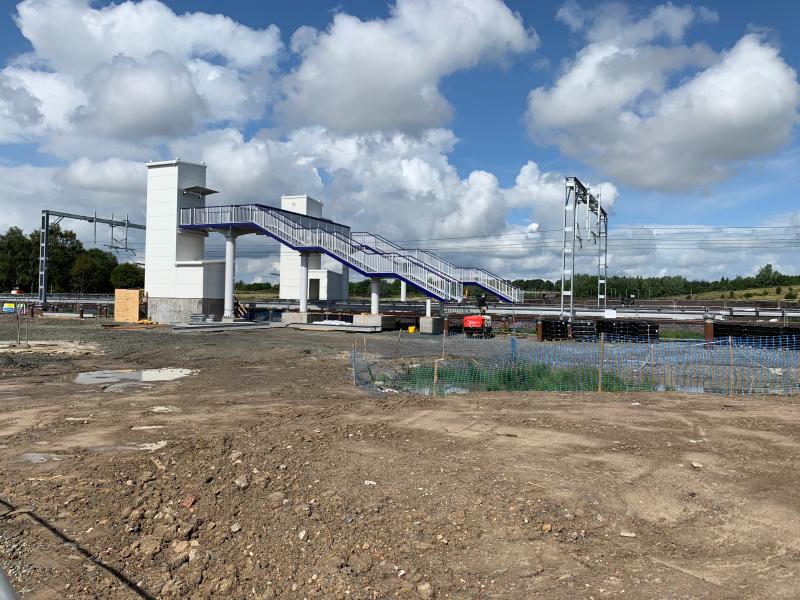 New Robroyston Station: The new station site from the south (Millerston) boundary 12/08/19. Footbridge and lifts well advanced and supports for platforms evident. Photo of New Robroyston Station