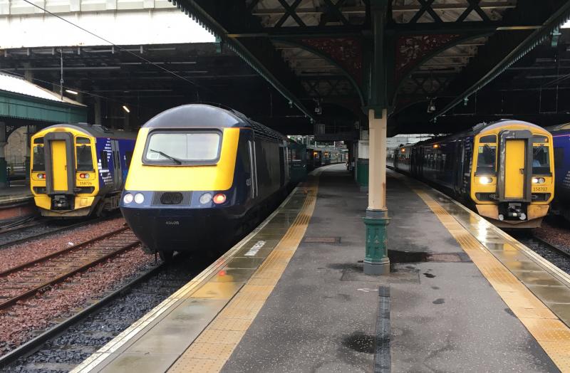 Scotties Lineup: Two Class 158 Express Sprinter DMUs 158724 (left) and 158707 (right) and in the middle, HST set lead by 43026 all stand at Edinburgh Waverley on 05/10/2019 Photo of Scotties Lineup