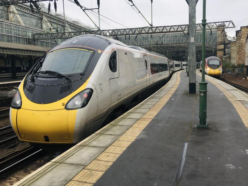 Before and After: In platform 1, new Virgin livery Pendolino 390044.
In platform 2, fully debranded Photo of Before and After