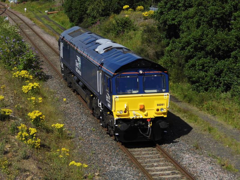66091 repainted in DRS blue: 66091 on 0Z07 0917 Motherwell- Craigentinny light engine approaches Niddrie Junction on 28/07/20. This loco was formerly in EWS livery and was recently acquired by DRS and painted in their blue livery. Photo of 66091 repainted in DRS blue