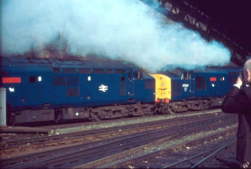 Newly named : In a cloud of blue exhaust, led by 37027 now LOCH EIL and 37026 LOCH AWE, the four locos make their way out of Queen Street after being named.
The other two became LOCHS LOMOND and LONG. Photo of Newly named