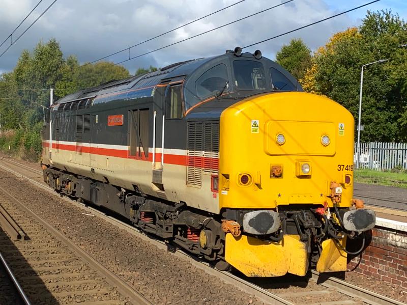 Job's Done: Having been replaced with 37038 on the PLPR, 37419 is seen thrashing through Holytown headed for Carlisle Kingmoor. Photo of Job's Done