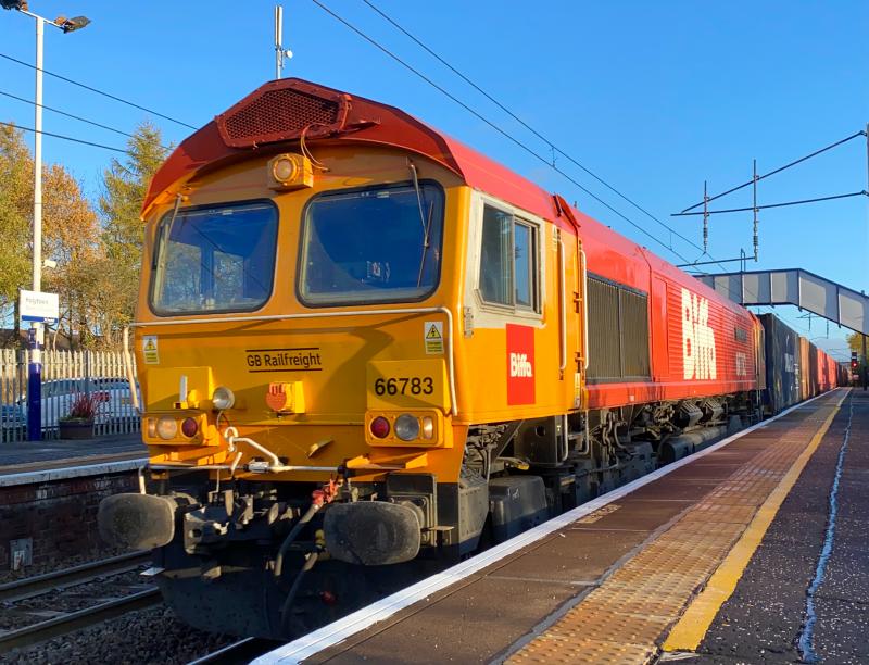 Flying Dustman Flies Again: On the first week of a new intermodal link between Doncaster and Elderslie, Celeb Shed 66783 in Biffa livery does the honors as it heads 4S69 through Holytown in dimming sunlight. Photo of Flying Dustman Flies Again