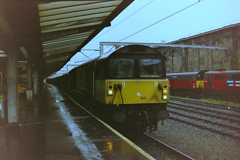 58015 at Carlisle: 58015 heads North with an MGR train through platform 1 at Carlisle in October 1998. Photo of 58015 at Carlisle