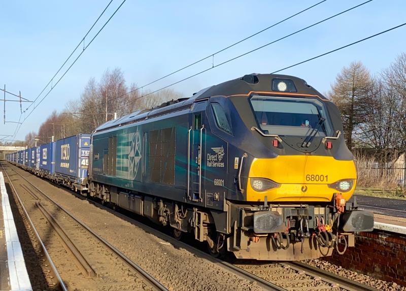 Cat Number One: Heading southbound with the 4E65 Mossend - Tees Dock intermodal, 68001 rumbles through Holytown on the sunny morning of 21/02/2021 with a full load of Tesco boxes. Photo of Cat Number One