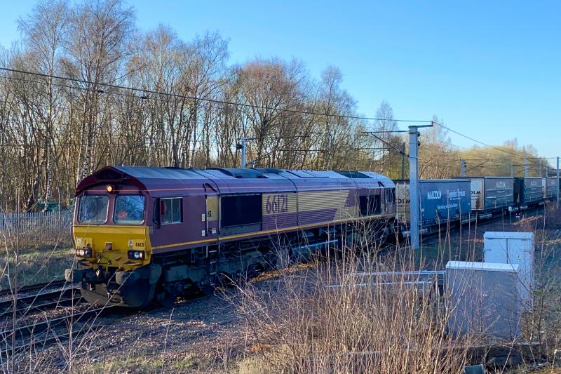 Lineside Shed: Running in an earlier path, and routed via Motherwell, DB Class 66 no. 66121 leads the 4M30 Grangemouth - Daventry past Mossend South Junction (01/04/2021) Photo of Lineside Shed