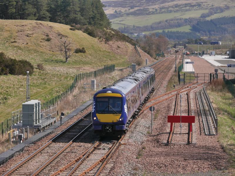 Blackford 170: 170410 passes the trackless Blackford Freight Terminal with the 12.16 Dundee - Glasgow Queen Street on 21 April 2021. Photo of Blackford 170