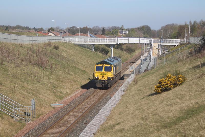 Class 66 at Eskbank: Freightliner class 66 no. 66 596 - locomotives are an unusual sight on the Borders Railway in daylight - passes Eskbank on what may have been a route learning trip on 23.4.21. Photo of Class 66 at Eskbank