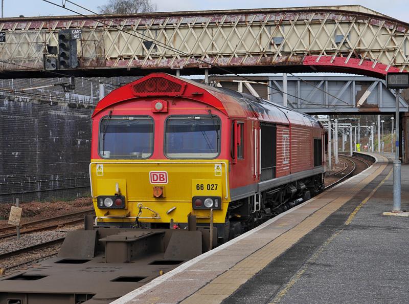 red 66: DB red 66027 draws a Tees Dock - Grangemouth intermodal through Carstairs on 30 April 2021. Photo of red 66