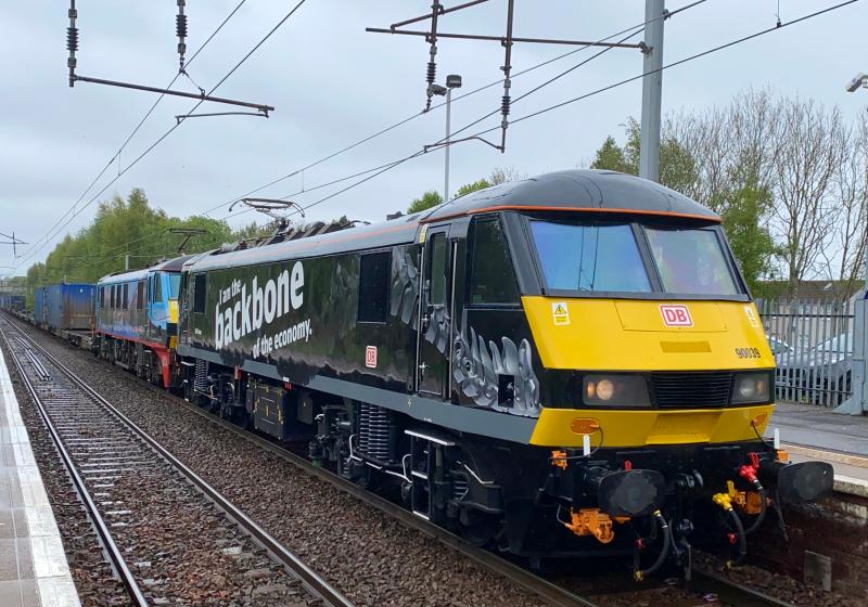 Back in Black: DB Cargo 90039, in its Backbone of the Economy black livery heads a late running 4M25 Mossend - Daventry through Holytown double headed with Malcolm livery 90024. (21/05/2021) Photo of Back in Black