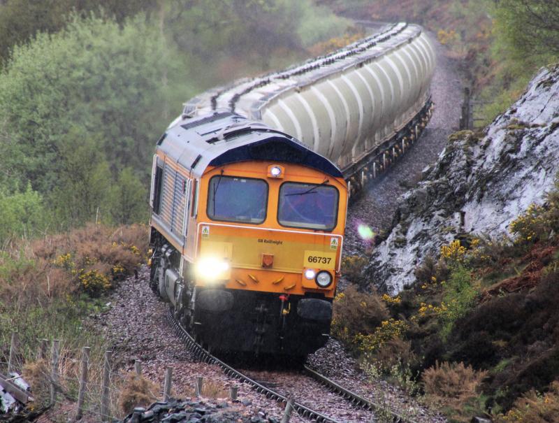 ALCANS TO BLYTH: Monday 24th May 66737 heads the Alcan to Blyth in pouring rain , north of Crianlarich . Photo of ALCANS TO BLYTH