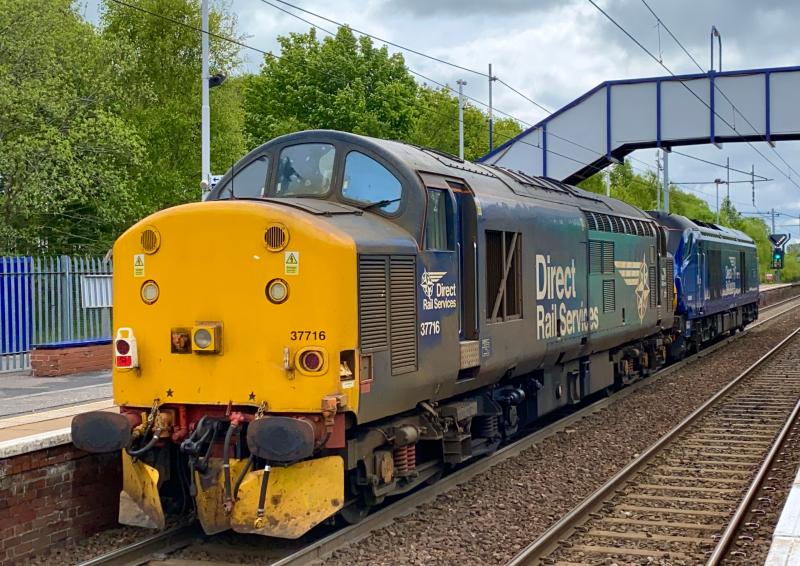 Trailing Tractor: DRS 37716 dead in tow behind 68007 working the 0M69 Motherwell TMD - Carlisle Kingmoor light loco move passing through Holytown in overcast conditions. (24/05/2021) Photo of Trailing Tractor