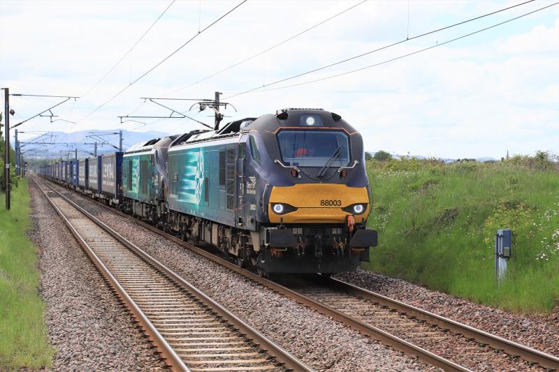 4M48: 88003 + 68017 on 4M48 12.13 Mossend Euroterminal to Daventry with 16 twins approaching Wallyford on 06/06/2021. Photo of 4M48