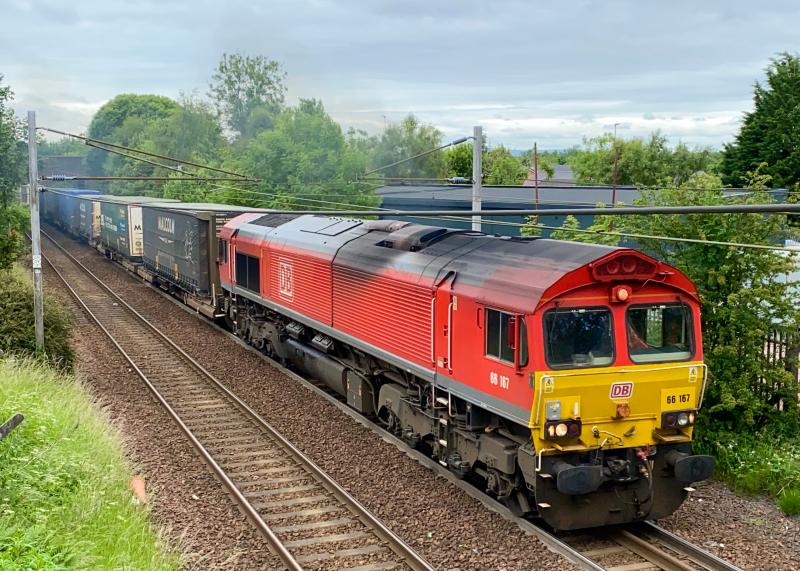 Overhead Shed: DB red liveried 66167 accelerates on the approach towards Holytown working the 4M30 Grangemouth to Daventry container train running close to an hour late after a prolonged stop in Mossend. (26/06/2021) Photo of Overhead Shed