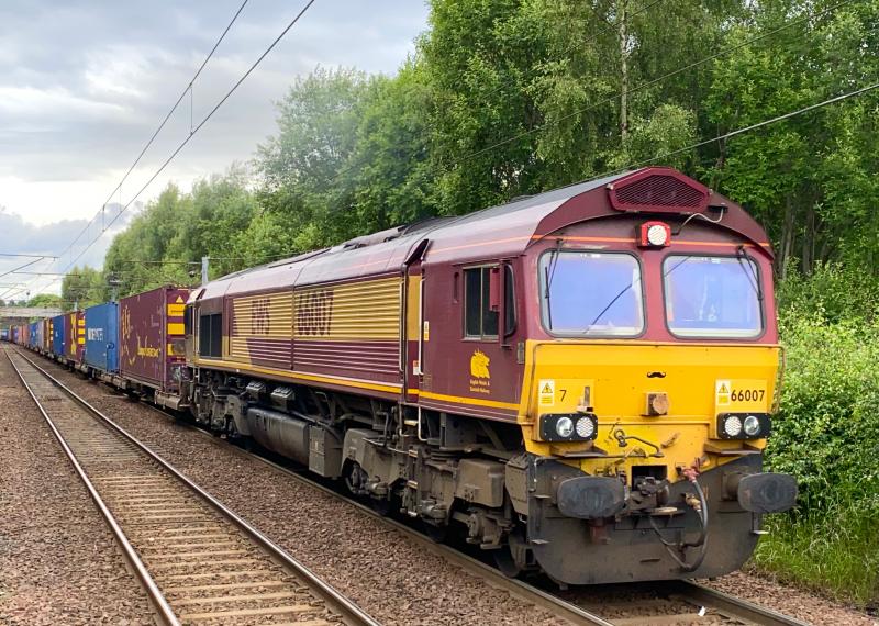 Shed with a Stache: DB Cargo owned, but still EWS branded 66007 heads the 4E99 Grangemouth - Tees Dock intermodal on approach to Holytown station on a generic overcast afternoon. (05/07/2021) Photo of Shed with a Stache