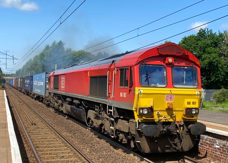 Saturday Shed 1: DB Red 66167, powers through Holytown at the head of the 4M30 Grangemouth - Daventry intermodal, producing a rather unhealthy amount of clag on approach. (17/07/2021) Photo of Saturday Shed 1
