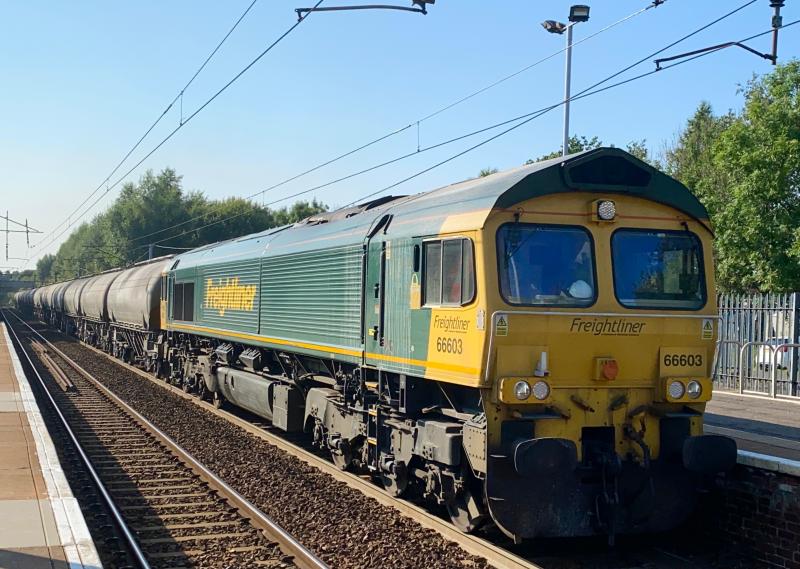 Cement Fred: Freightliner 66603 in racing green livery speeds through Holytown at the head of the 6E34 Viewpark - Tunstead Sidings empty cement tankers. (20/07/2021) Photo of Cement Fred
