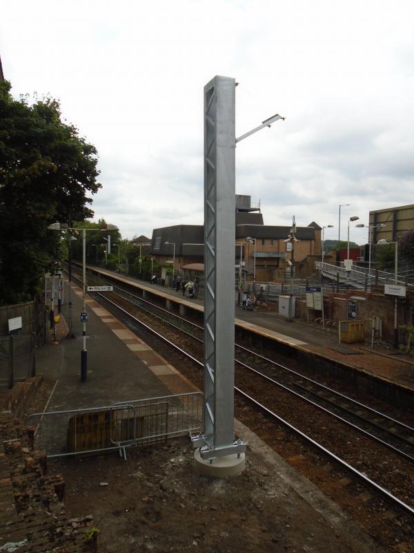Crossmyloof station: Electrification equipment starting to appear on the Barrhead line. Photo of Crossmyloof station