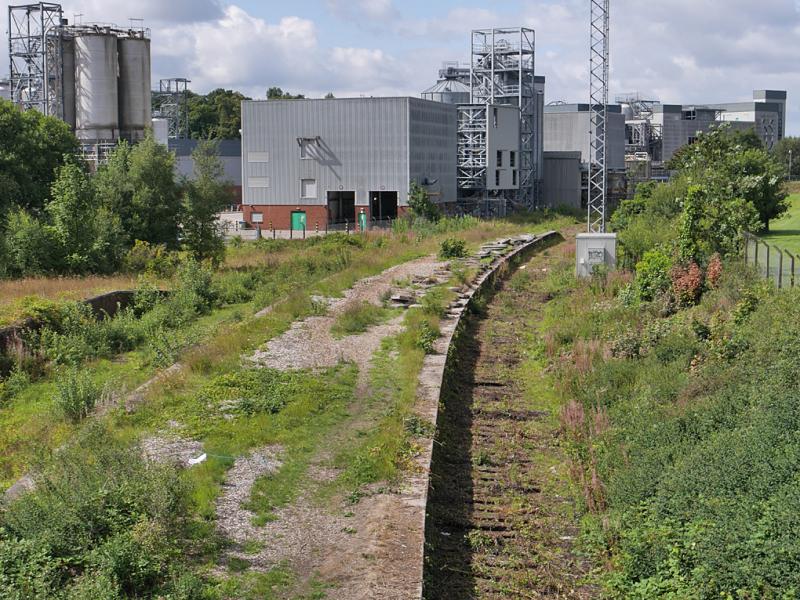 Cameron Bridge lifted: Looking west from the Station Road bridge over the former station. The through line to Methil has been lifted as far as East Fife Central Junction but the yard track remains in place. 16 August 2021 Photo of Cameron Bridge lifted