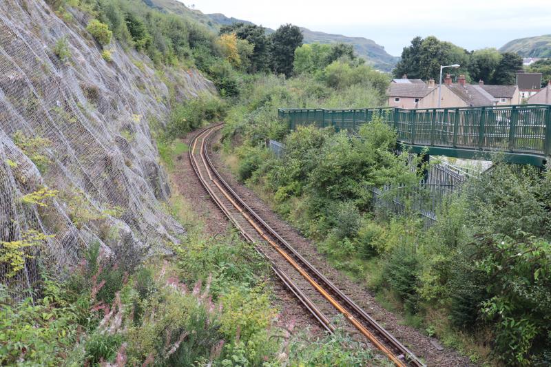 Replacement track awaiting Installation : Taken today. Replacement rails running from the pedestrian bridge at Soroba, Oban down to O/B OBN2/281.No sign of any new ballast. Photo of Replacement track awaiting Installation