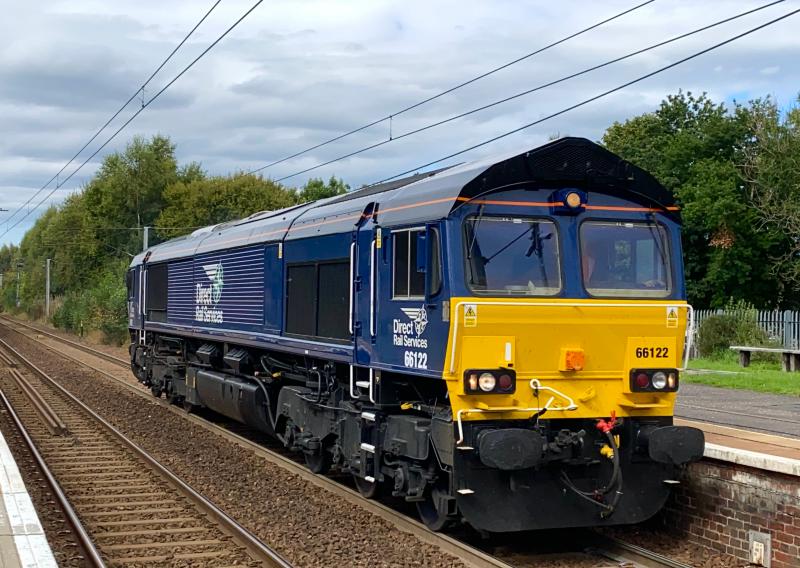 Ex-Shed: On long term hire from DB Cargo, DRS livery 66122, formerly in EWS livery runs southbound through Holytown working the 0M69 Motherwell TMD - Kingmoor light loco move. (13/09/2021) Photo of Ex-Shed