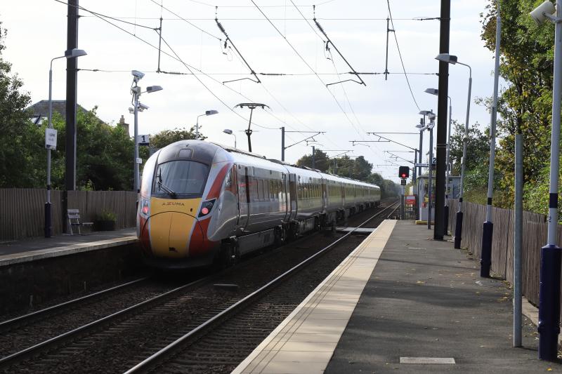 1E23: 800107 on 1E23 11.47 Aberdeen to Kings Cross pasing through Kingsknowe Station with the pantograph up over the level crossing on 10/10/2021. Pantograph raised after Slateford station. Photo of 1E23
