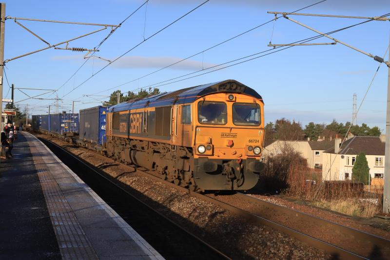 4E04: 66724 on 4E04 11.05 Mossend PD Stirling to Doncaster Iport passing Newcraighall Station on 05/01/2022 with 15 Twins and 4 containers. Photo of 4E04