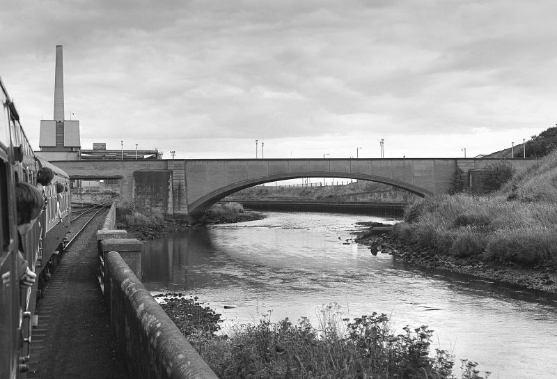 Bawbee Bridge: The 'Lothian & Fife Wanderer' nears the Bawbee Bridge, Leven on 23 August 1980 with Methil Power Station beyond. Photo of Bawbee Bridge