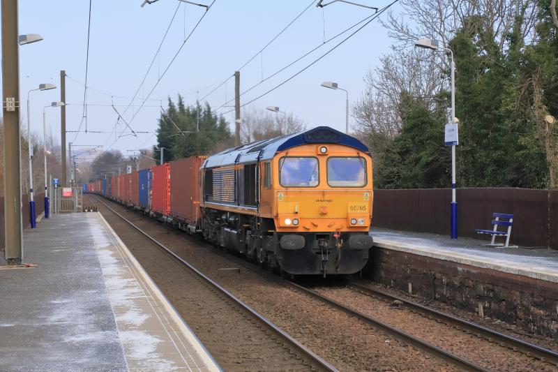 4S69: 66765 on 4S69 06.06 Doncaster Iport to Elderslie at Kingsknowe approaching the Level Crossing on 08/03/2022. The sun had luckily gone behind a cloud. 27 containers 1 space Photo of 4S69