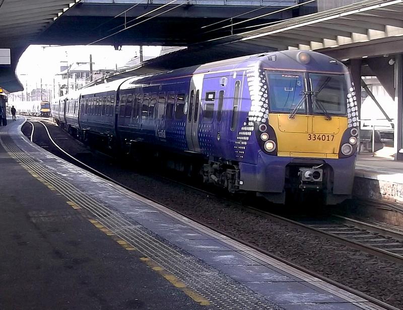334017 at Haymarket: ScotRail Juniper 334017 arrives at Haymarket with a service from Helensburgh Central on 19th March 2022. Classmate 334037 is on the rear. Photo of 334017 at Haymarket