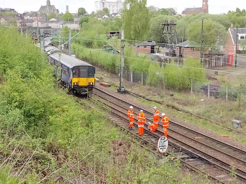 318265 derailed at Sunnyside Junction: Engineers examine the points behind 318265 which derailed along with 320309 on the evening of 6th May 2022 while heading for the Whifflet line at Sunnyside Junction. Photo of 318265 derailed at Sunnyside Junction