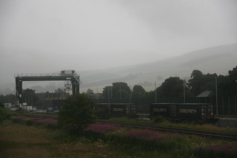 Container Crane, Blackford on 23.07.2022: Container crane in the Highland Spring yard on 23rd July 2022 straddling the tracks and having the spreader, together with the four containers delivered earlier this week. Photo of Container Crane, Blackford on 23.07.2022