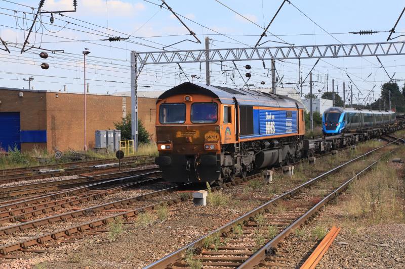 4S57: 66731 (Dirty Cab) leading 4S57 10.25 Hams Hall to Mossend Euroterminal 397008 on 1M60 15.08 Glasgow Central to Manchester Picadilly at Carlisle, First container of 6 visible above the front of 397008. Photo of 4S57