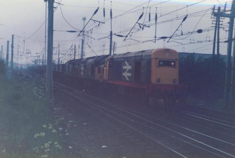 Triple header leaves Mossend Yard: A Class 20 pilots out 2 class 37's on an MGR triple header at Mossend Yard on it's way to most likely Ravenscraig. Photo of Triple header leaves Mossend Yard