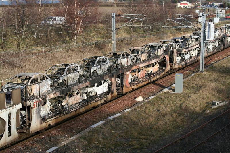 Hot new motors: The charred remains of some French imported vehicles pass Blindwells. Photo of Hot new motors