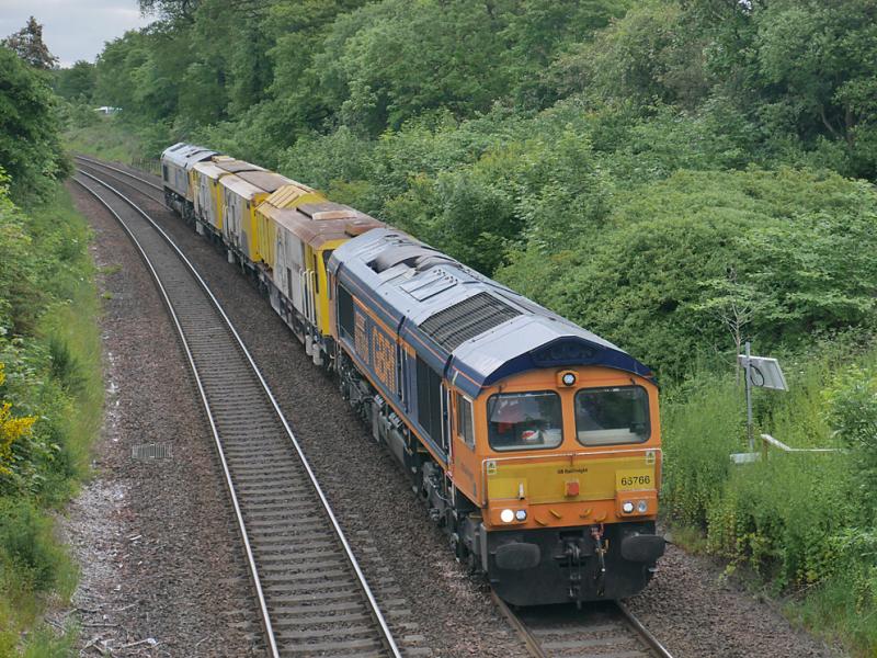 6X69: 66766 and 66717 near Dalgety Bay with a track machine moving from Montrose to Slateford Depot on 9 June. Photo of 6X69